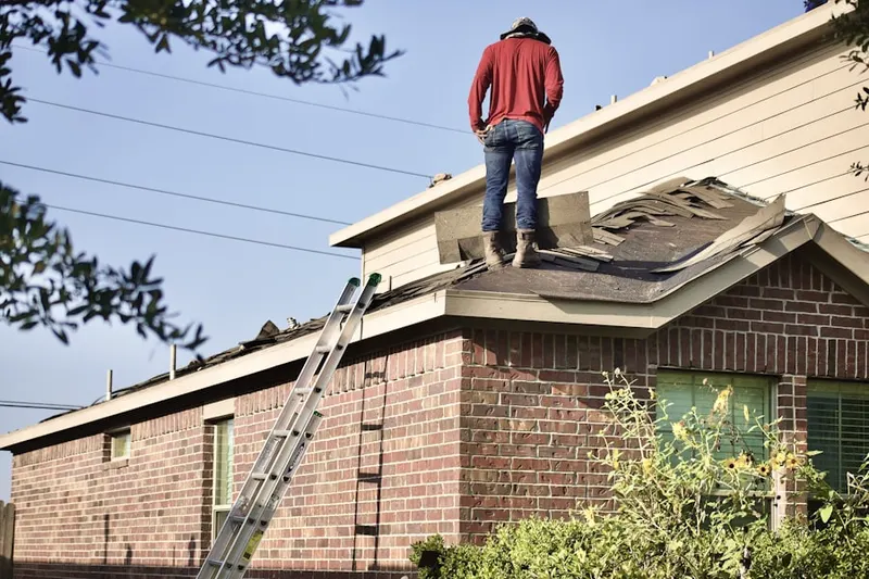 Professional roofer working on a residential roof in Winters
